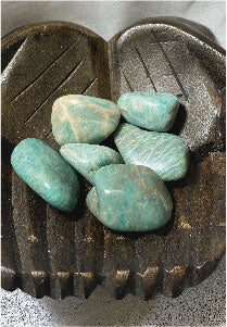 Turquoise stones on a textured wood surface