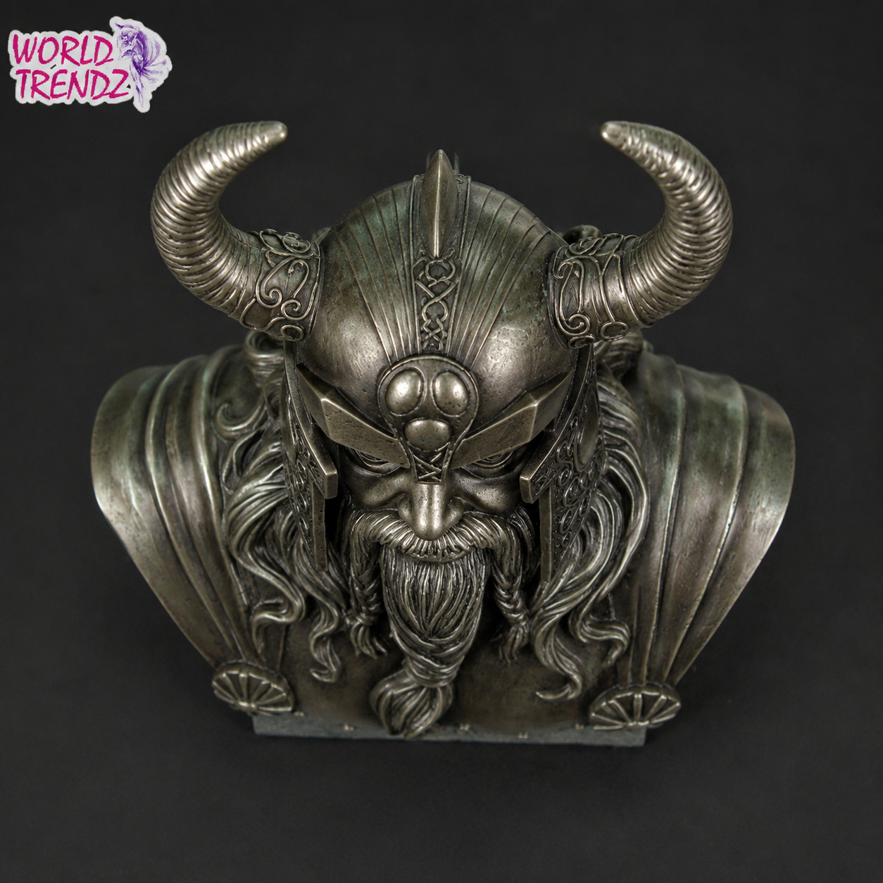A detailed Odin Cold Cast Bronze Statue with long hair and beard, crafted in a textured metallic silver-gray finish, set against a solid black background. A 'World Trendz' logo is visible in the top-left corner.