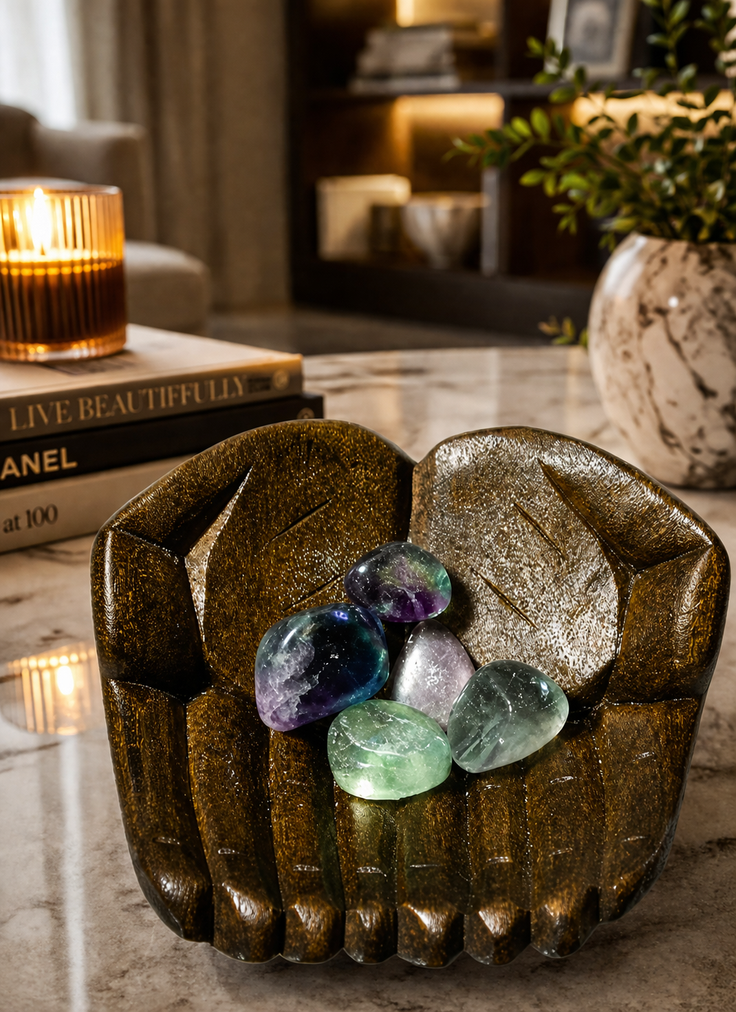 Wooden hand bowl with Fluorite stones as a premium décor piece on a modern marble tabletop.