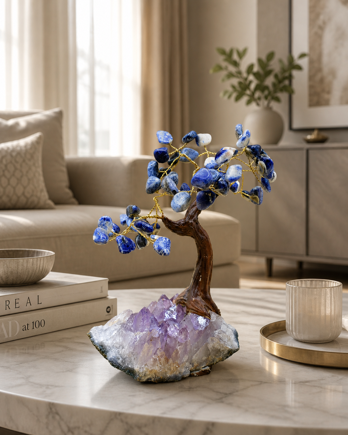 Sodalite gemstone tree as a centerpiece on a modern living room coffee table, surrounded by neutral-toned furniture and soft natural lighting, emphasizing its calming blue hues and elegant crystal base.
