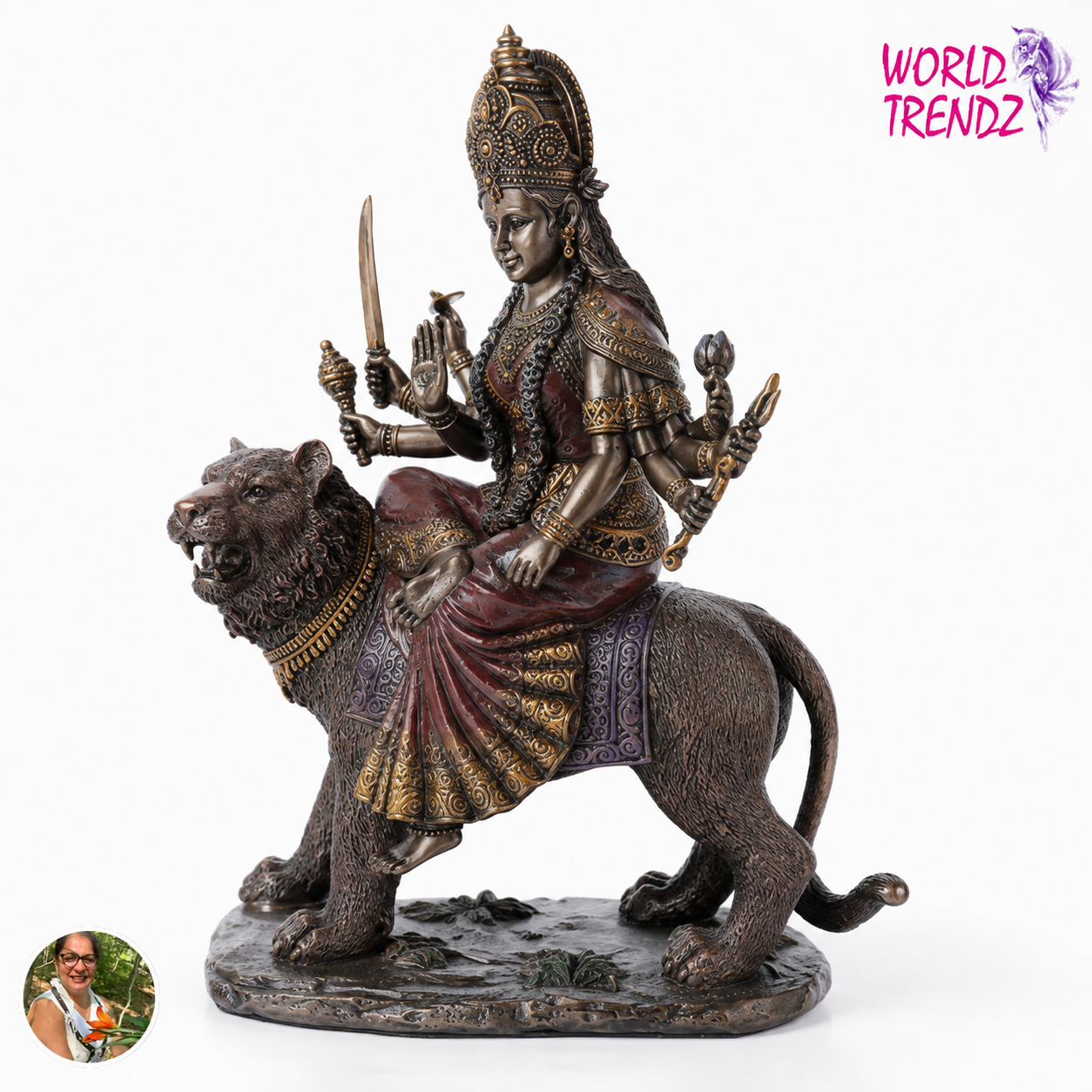 A bronze-finished statue of Goddess Durga riding a lion, shown against a plain white background. A 'WORLD TRENDZ' logo is visible in the top right corner, and a small circular photo inset appears in the bottom left corner.