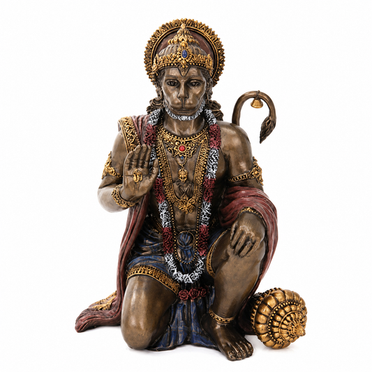 Statue of a Hanuman deity with intricate jewelry and a crown on a white background