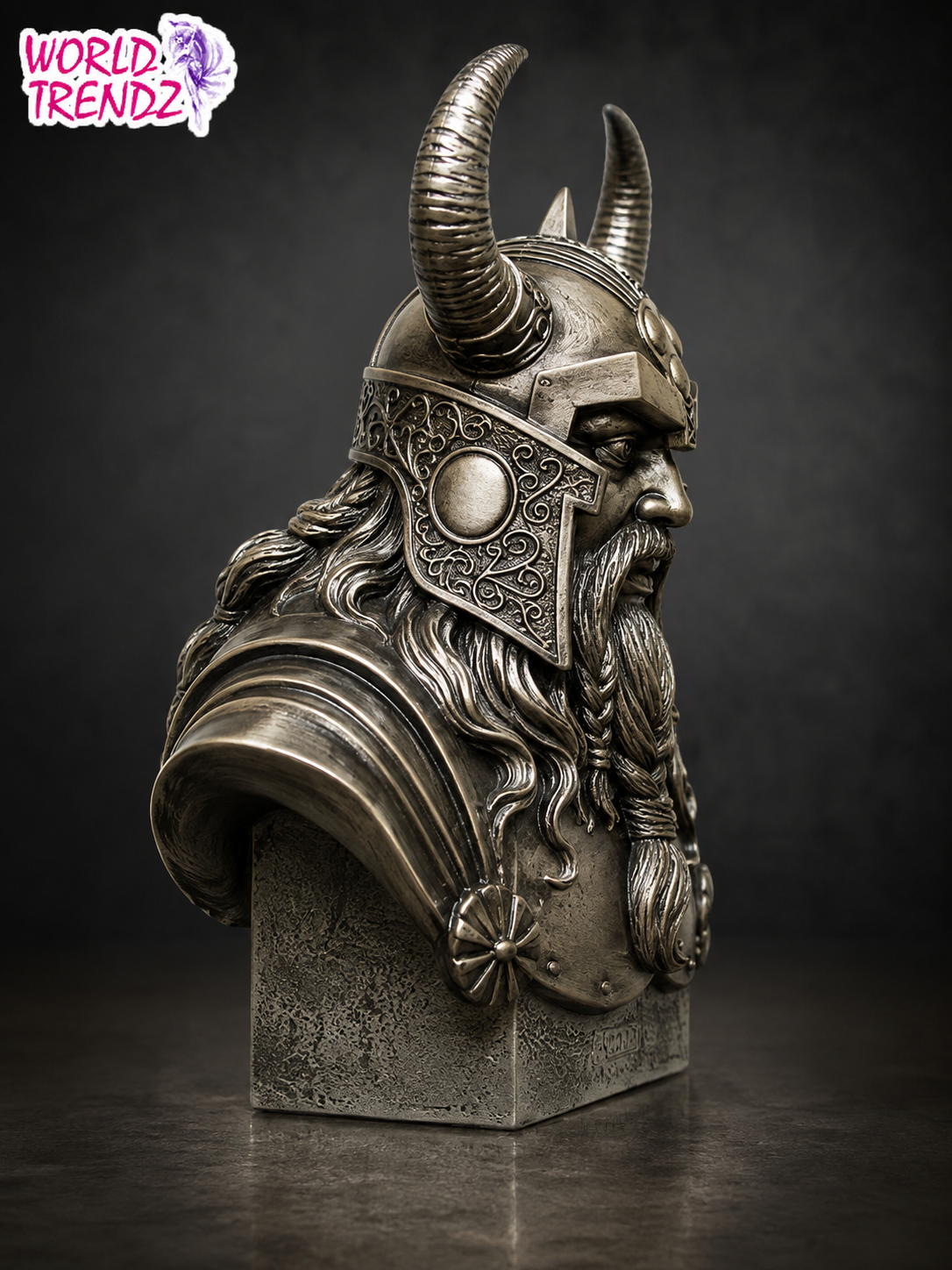 A detailed bust sculpture of Odin Cold Cast Bronze Statue with a long beard, crafted in a textured metallic silver finish, displayed on a dark pedestal against a dark gray background.
