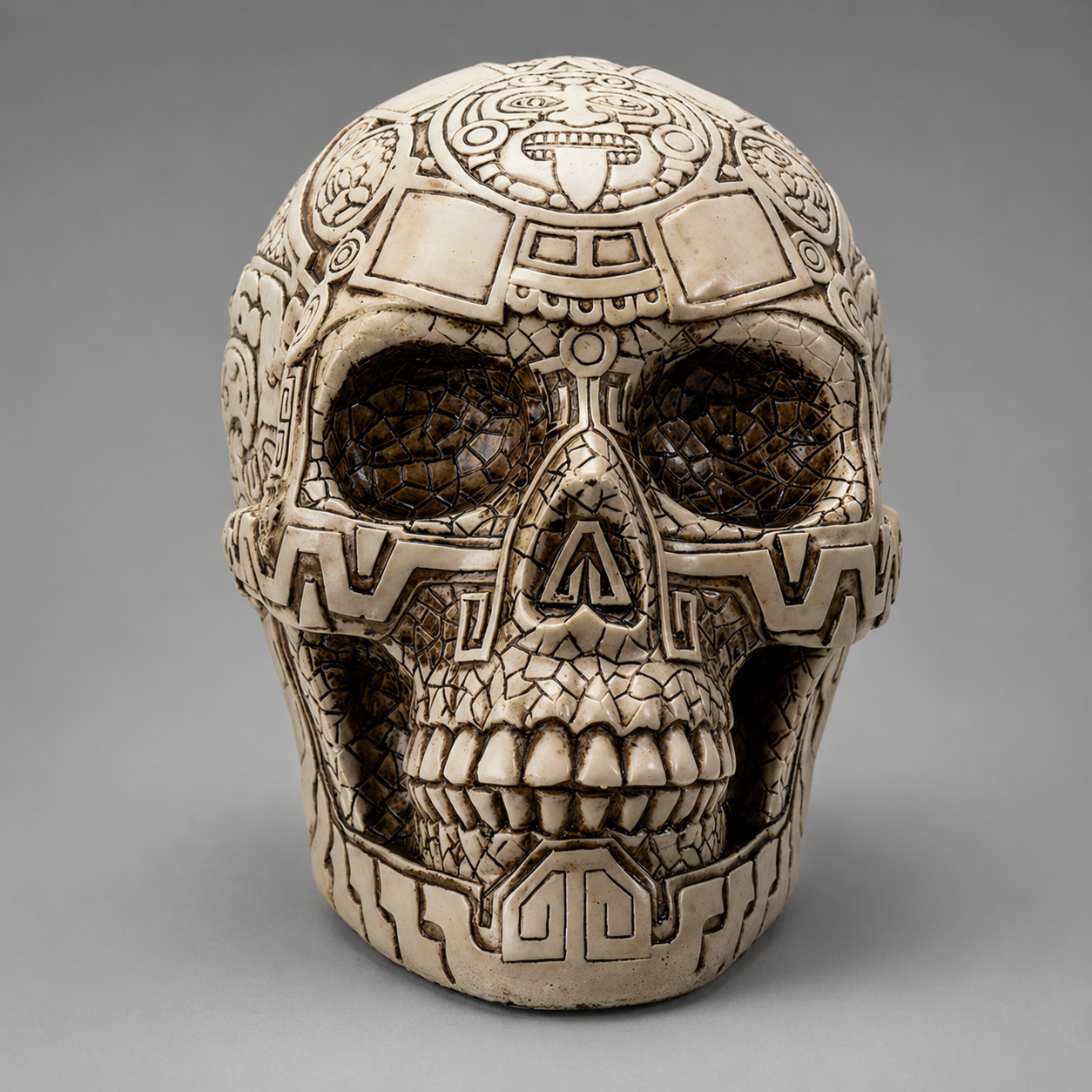 Decorative Aztec skull with intricate patterns on a gray background