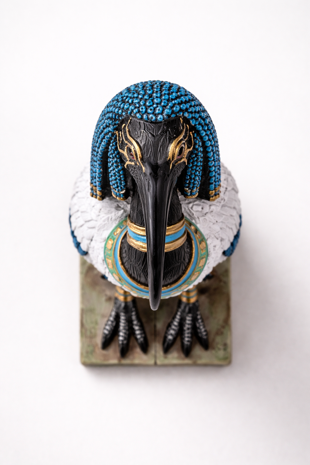 Decorative figurine of a bird with blue head and white body on a white background