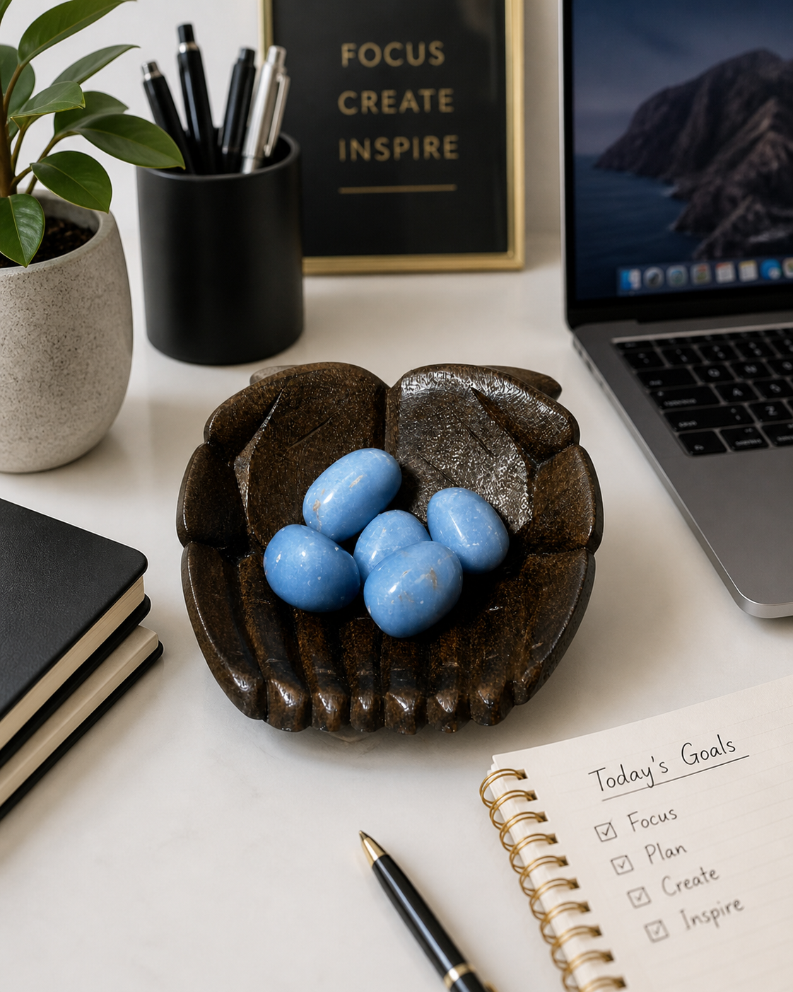 Angelite gemstone presented as part of a modern workspace environment. Bright, balanced lighting with subtle reflections, suggesting the stones are placed on a desk for focus, creativity, and mental clarity. Clean, professional aesthetic with a hint of productivity and intention.
