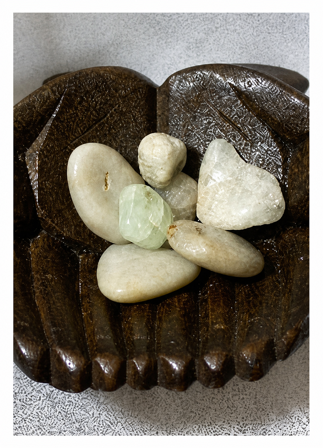 Decorative wooden bowl with Aquamarine stones on a textured surface