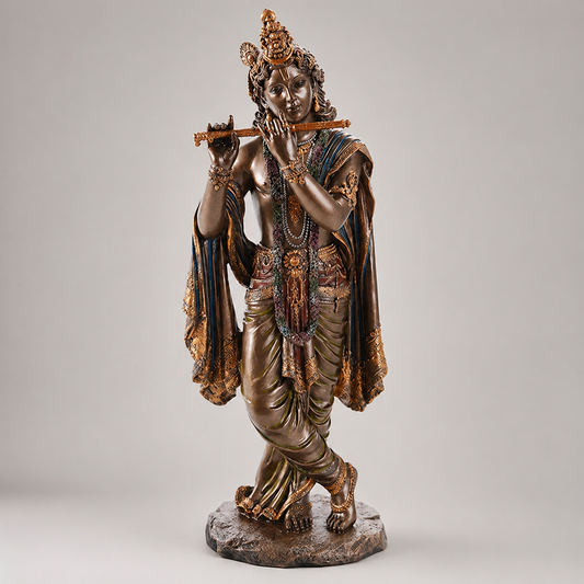 Statue Krishna holding a flute on a gray background