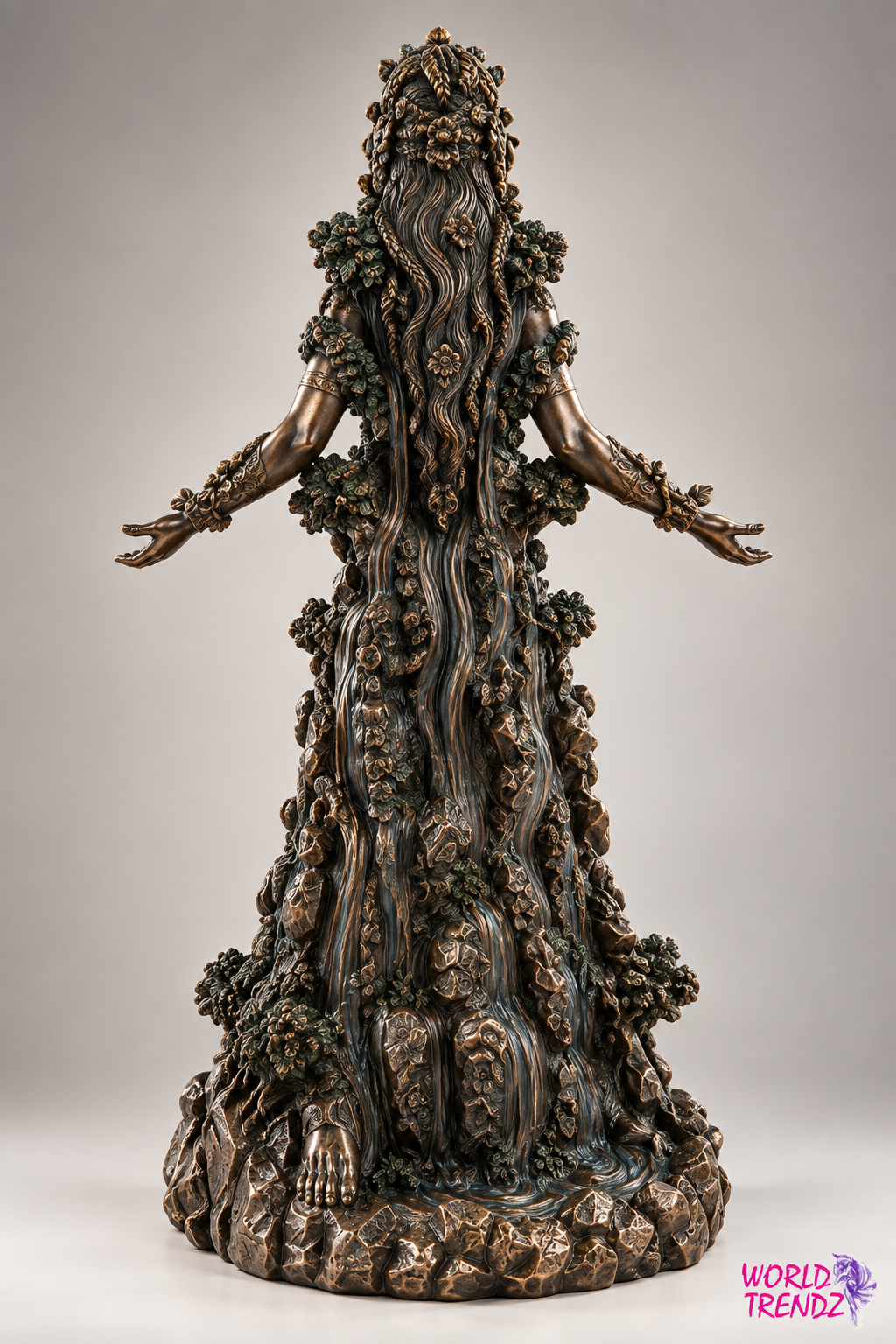 A dark bronze gothic Goddess Danu sculpture with outstretched arms, detailed with faces and vines, standing on a rocky base against a neutral gray background.