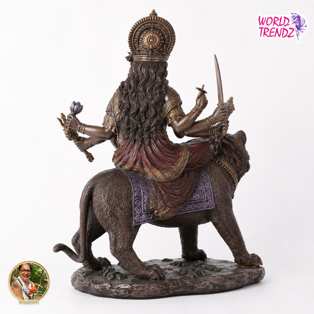 A detailed bronze-finished statue of a Hindu goddess Durga riding a lion, shown from the back against a plain white background. The statue features intricate carvings, a crown, multiple arms, and a textured base.