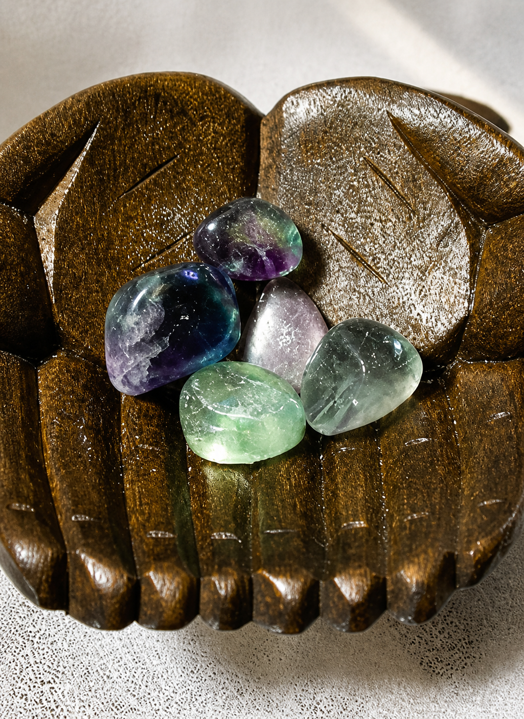 Fluorite Stones in Carved Wooden Hand