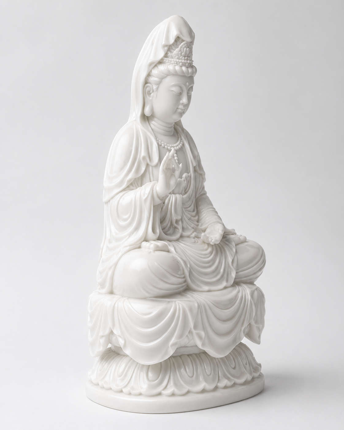 White ceramic statue Kuanyin on a white background