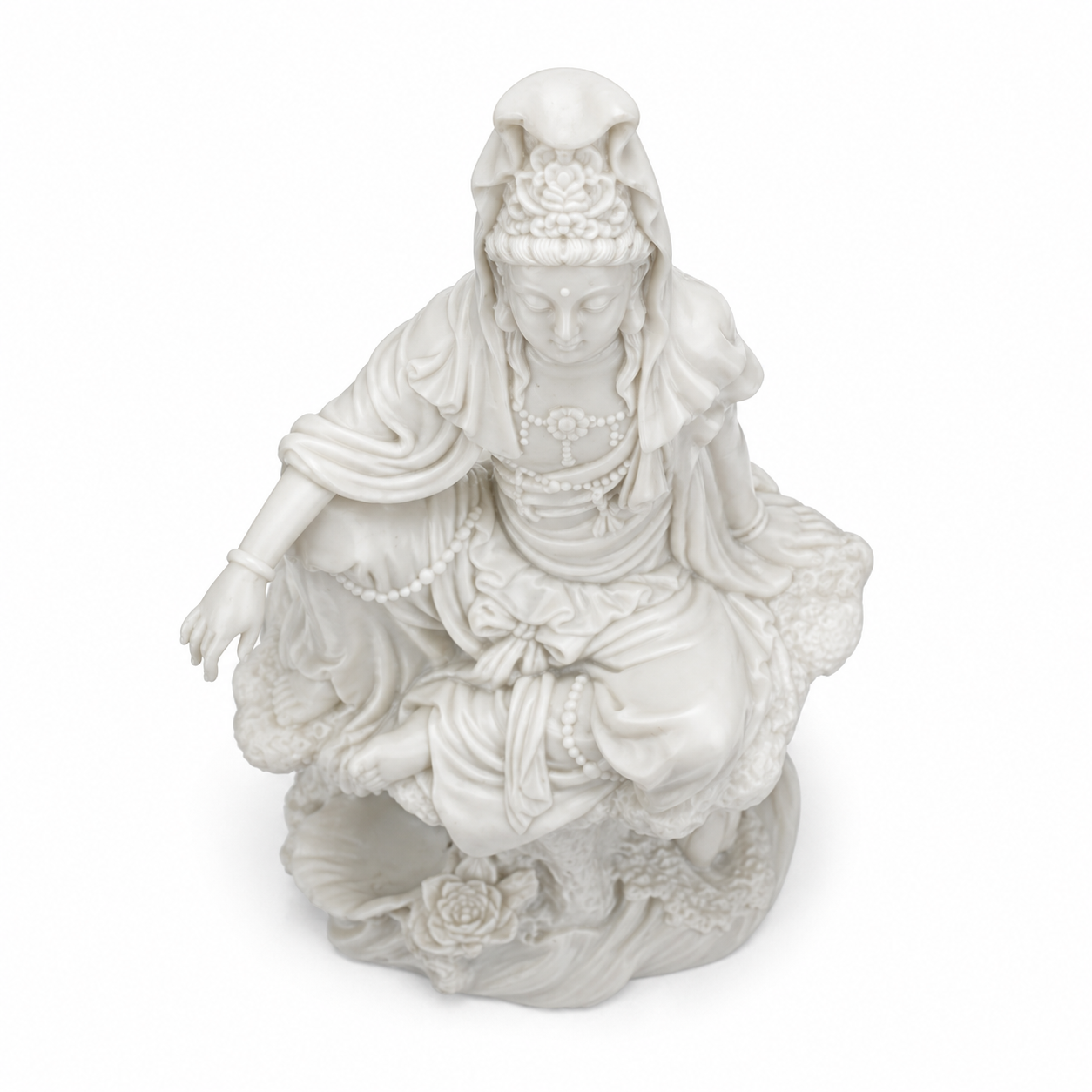 White ceramic statue of Kuan Yin on a white background