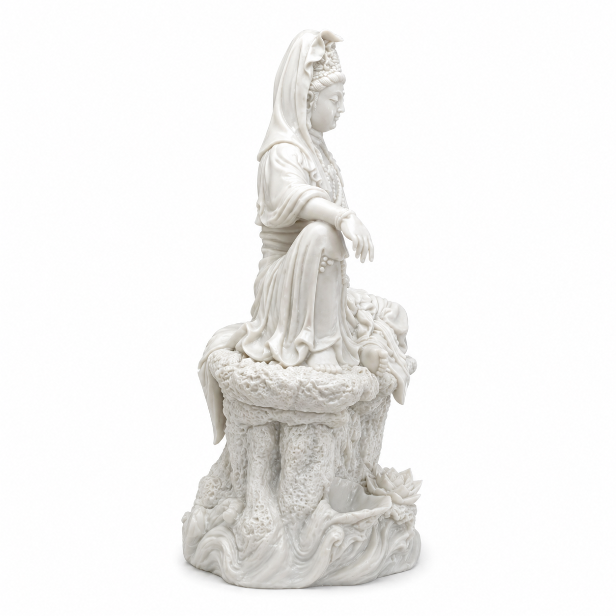 White statue of a Kuan Yin on a white background
