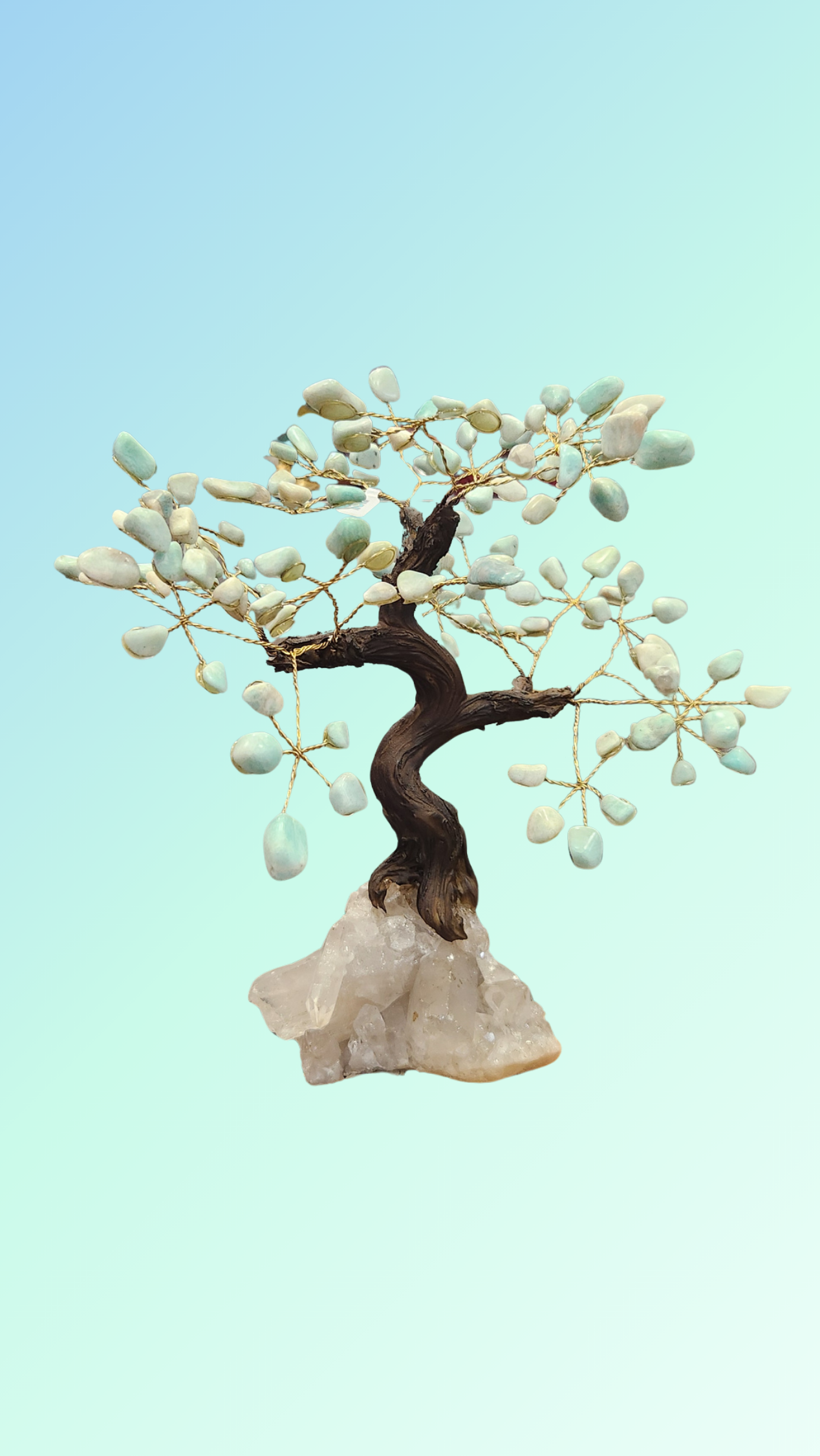 Artificial aventurine bonsai tree with branches on a light blue background