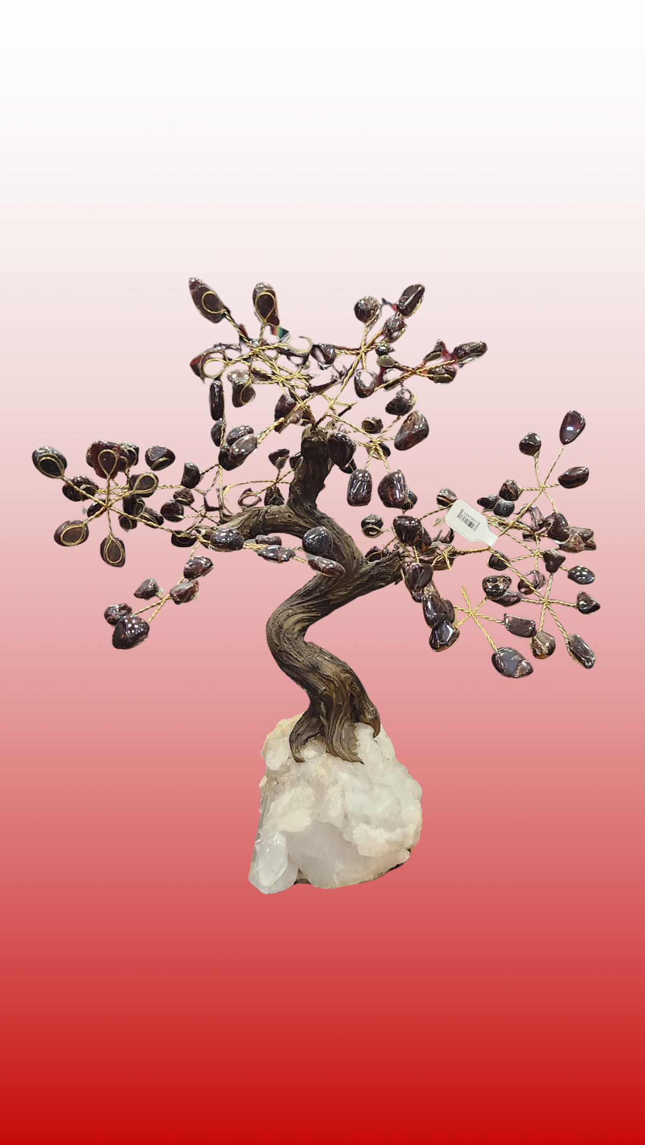 Decorative bonsai tree sculpture on a white base with a gradient pink to red background